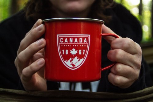 Canada 1867 mug held by two hands