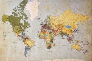Wall map of the world with lots of colored pins.